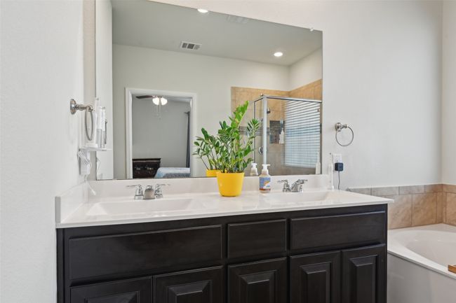 Ensuite bathroom with a shower stall, double vanity, a bath, and recessed lighting | Image 32