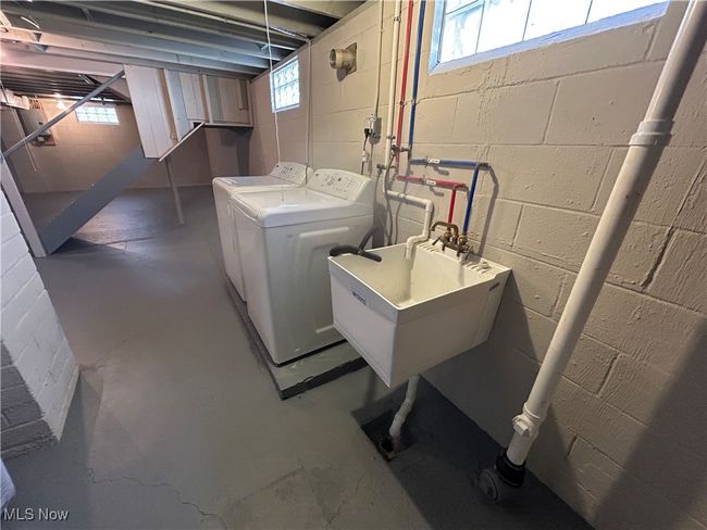 Laundry area with laundry area, independent washer and dryer, and a sink | Image 38