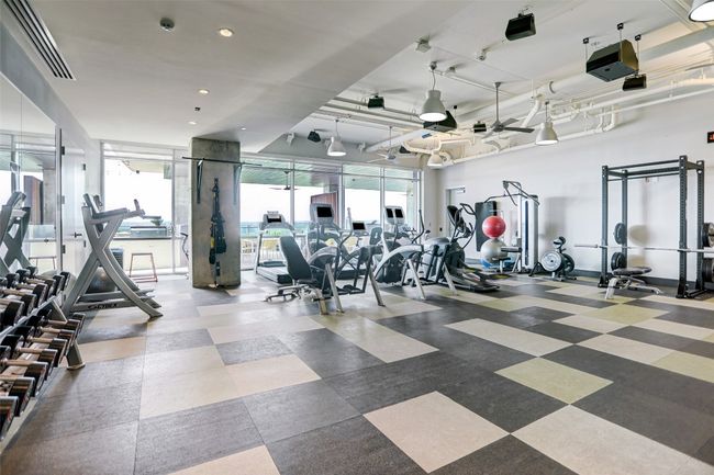 Workout area with recessed lighting, baseboards, and a wall of windows | Image 39