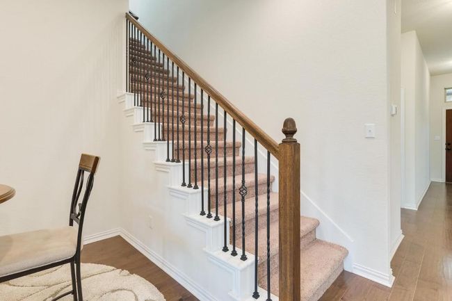 Staircase with wood finished floors and baseboards | Image 25