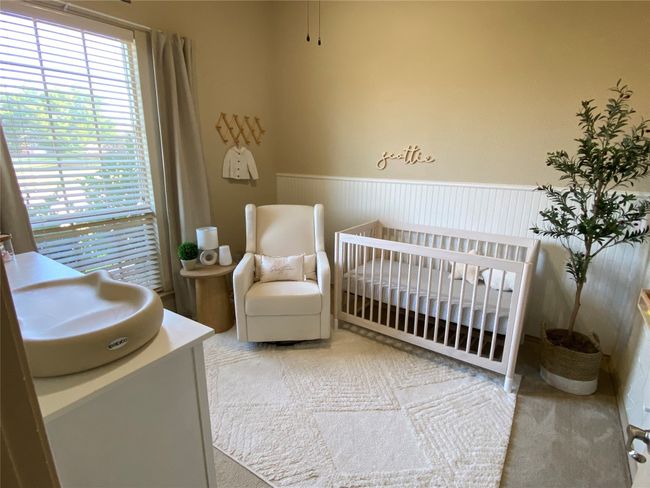 Bedroom with windows, carpet flooring, and a wainscoted wall | Image 6