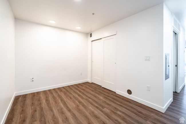 Spare room with visible vents, baseboards, and wood finished floors | Image 9