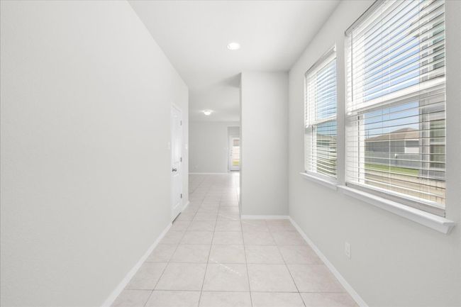 Hallway featuring light tile patterned flooring, baseboards, and recessed lighting | Image 6