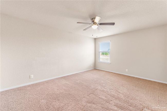 Unfurnished room featuring light carpet and ceiling fan | Image 24