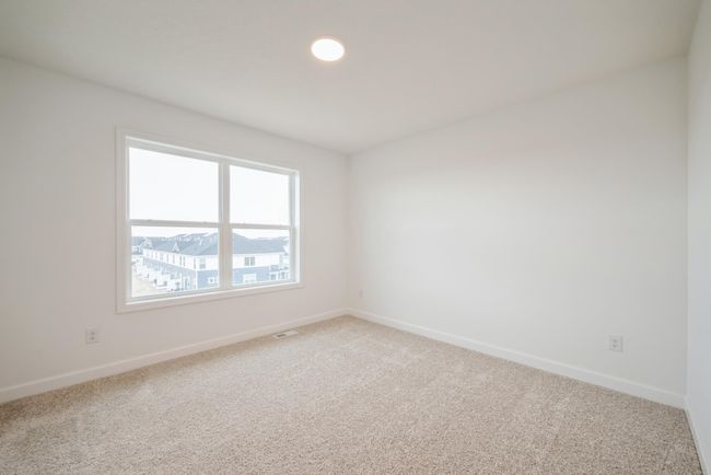 Photo is of the actual home. One of three secondary bedrooms. | Image 12