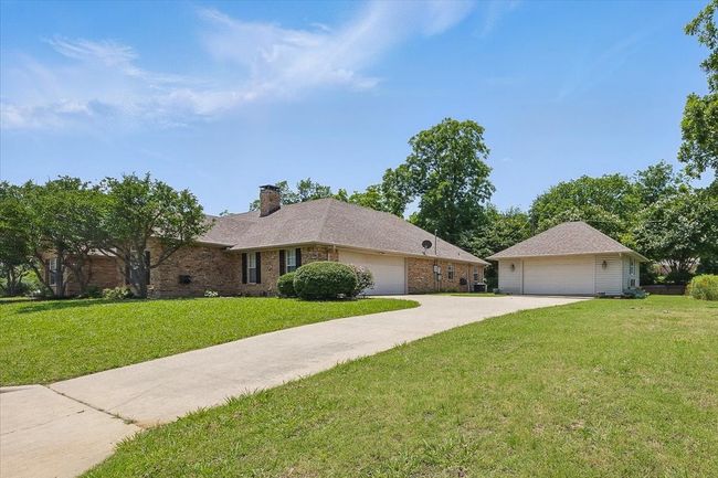 Single story home with a front yard, a chimney, brick siding, and a garage | Image 27