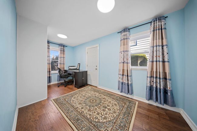 Home office featuring a wealth of natural light, baseboards, and wood finished floors | Image 8