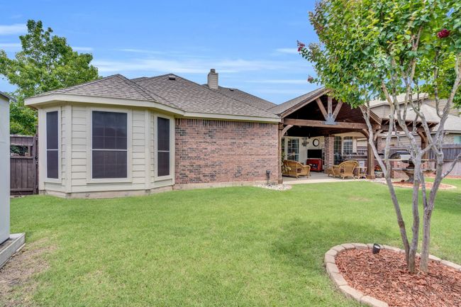 View of front of property with a patio, brick siding, a chimney, and roof with shingles | Image 37