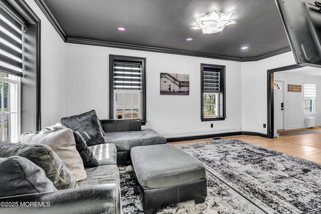 Comfy cozy family room with automatic shades and voice command recessed lighting. | Image 11