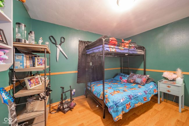 bedroom with baseboards and wood finished floors | Image 15