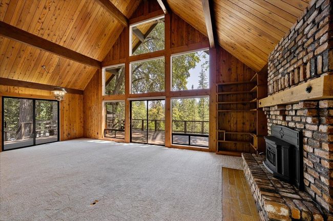 Clerestory windows light up main living area and offer beautiful wooded views. | Image 20