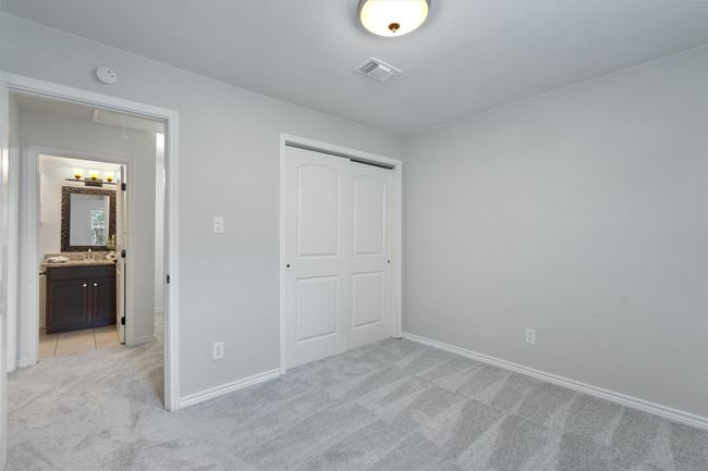 With plenty of natural light and ample closet space, the guest bedroom is designed for both comfort and convenience. | Image 24