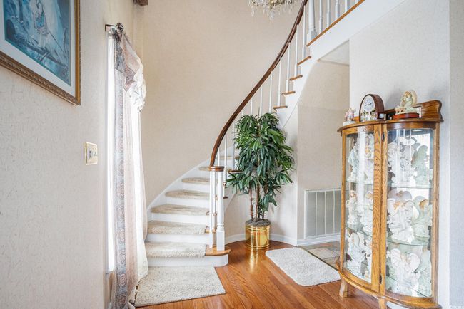 Foyer entrance featuring stairway and wood finished floors | Image 6