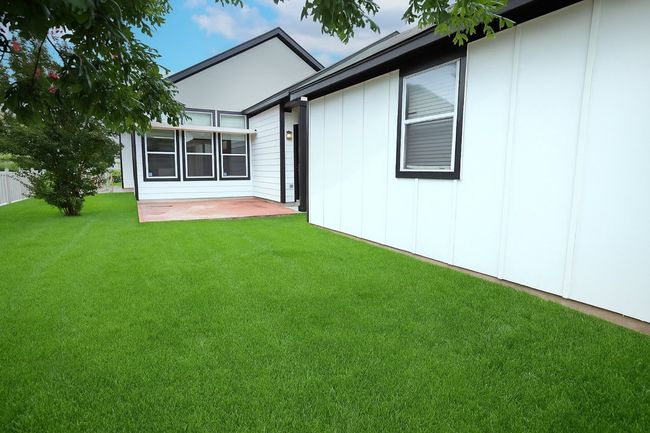 This charming Plum Creek gem also comes with a darling fenced-in backyard plus a two car detached garage with alley access from behind the homes. | Image 5