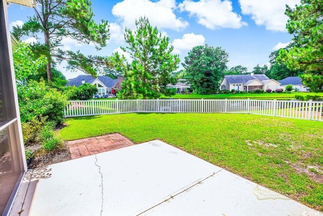 Fenced backyard with a patio area | Image 30