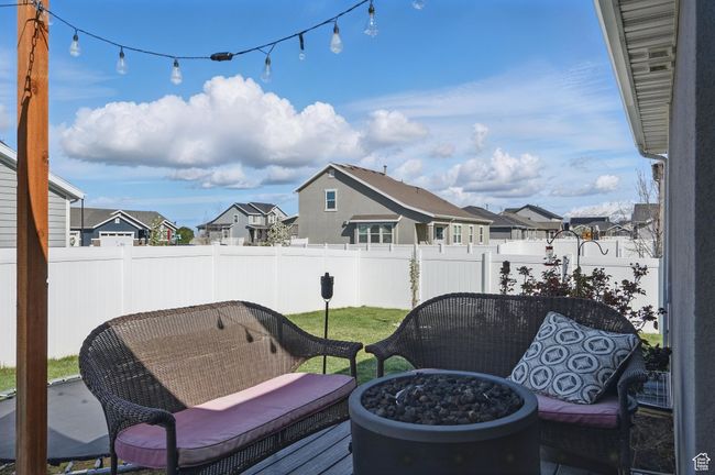 View of patio with a residential view, a fire pit, and fence | Image 46