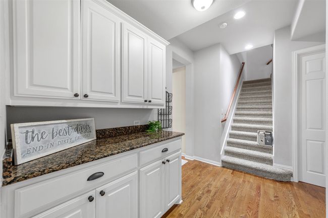 Bar with stairway, light wood-type flooring, recessed lighting, and baseboards | Image 26