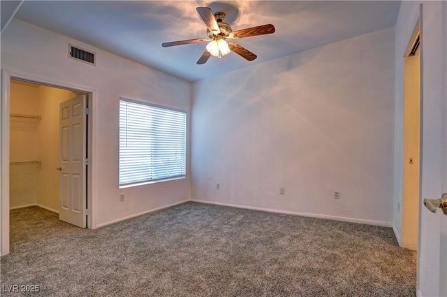 Unfurnished bedroom with carpet floors, a closet, baseboards, and a spacious closet | Image 12