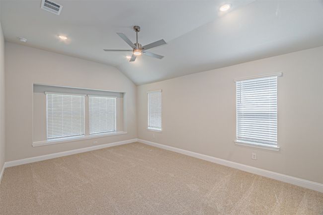Spare room with light carpet, a ceiling fan, vaulted ceiling, healthy amount of natural light, and recessed lighting | Image 22