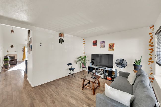 Living room featuring light wood-style floors and plenty of natural light | Image 5