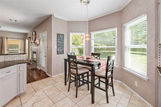 Dining area featuring ornamental molding, light tile patterned floors, a wealth of natural light, and baseboards | Image 7
