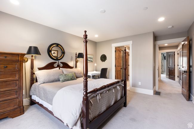 Bedroom featuring light colored carpet, recessed lighting, baseboards, and visible vents | Image 17