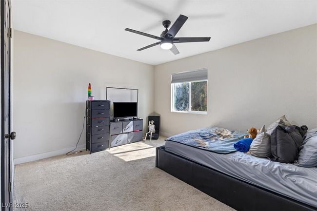 Carpeted bedroom featuring baseboards and a ceiling fan | Image 19