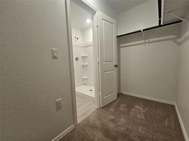Walk in closet featuring carpet floors | Image 18