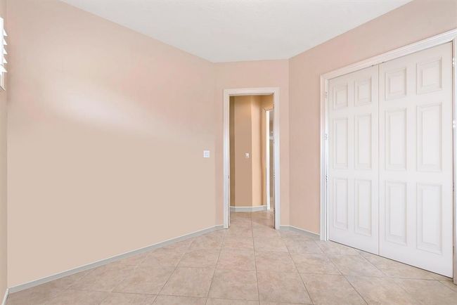 With a full bathroom located next to the Sunroom, this flexible floorplan also offers the option to be used as a 2nd Bedroom Downstairs. Alternate view showing there is space for a closet. Virtually rendered. | Image 14
