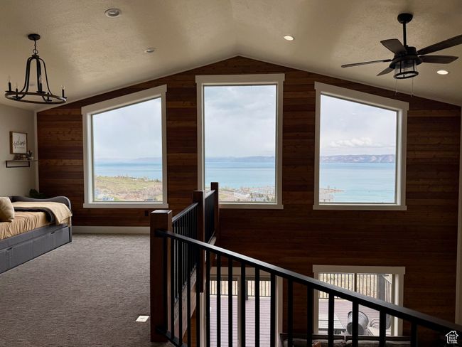 Loft featuring vaulted ceiling, wood walls, and carpet flooring | Image 30