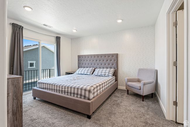Carpeted bedroom featuring a textured ceiling, access to outside, baseboards, and recessed lighting | Image 20