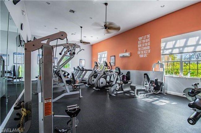 Exercise room with baseboards, visible vents, a ceiling fan, and plenty of natural light | Image 12