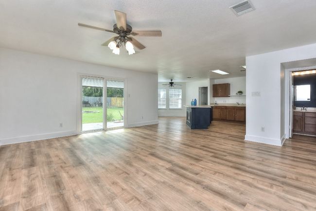 Another example of just how open this home's living spaces are....here is also a convenient powder room to the right. | Image 10