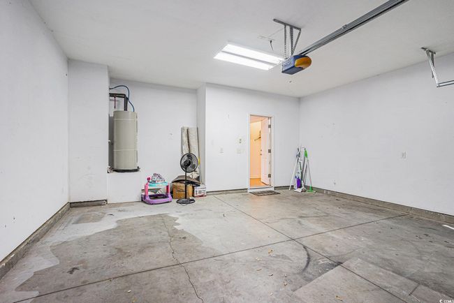 Garage with water heater and a garage door opener | Image 19