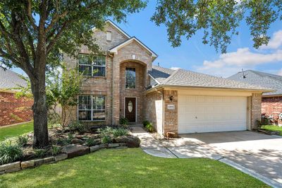 A meticulously maintained front yard shows how much pride in ownership and care has been put into this wonderful home! | Image 3