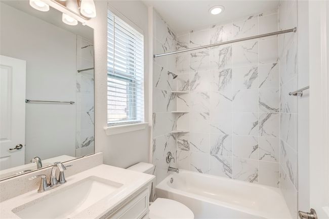 Bathroom with vanity, toilet, and bathtub / shower combination | Image 17