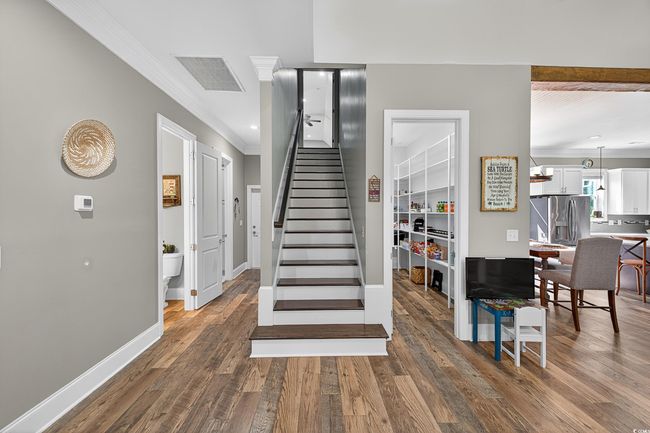 Staircase featuring crown molding and wood finished floors | Image 30