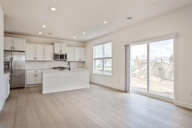 Photo is of the actual home. Adjacent to the kitchen is a dining area to enjoy meals with family and friends! | Image 4