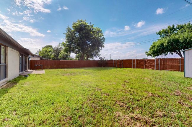 View of fenced backyard | Image 32