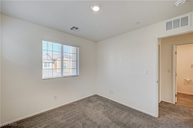 Carpeted spare room with a smoke detector and baseboards | Image 22