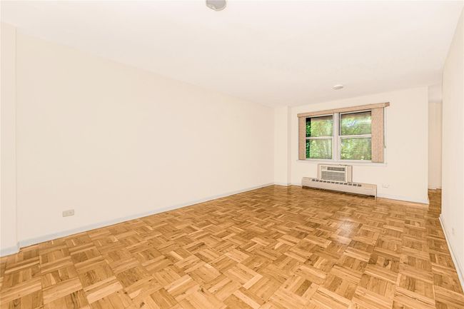 Spare room featuring baseboard heating and a wall mounted AC | Image 12