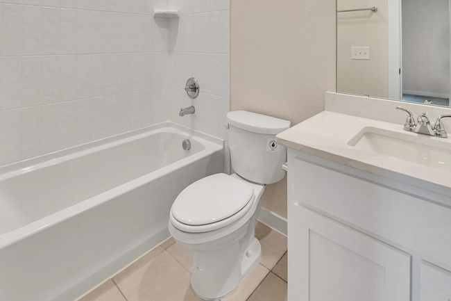 Bathroom featuring vanity, shower combination, and tile patterned floors | Image 17