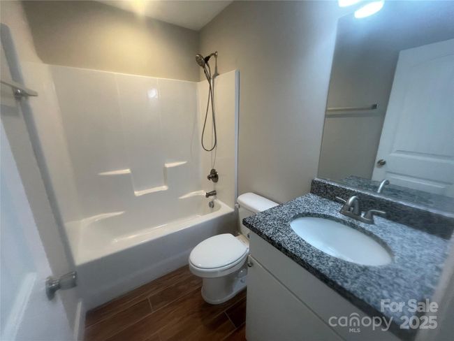 Second full bath with granite countertop and tile floor. | Image 12