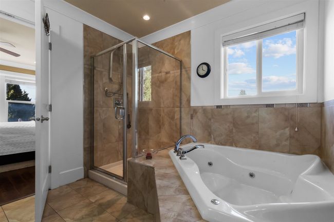 Ensuite bathroom with a shower stall, healthy amount of natural light, and a whirlpool tub | Image 19