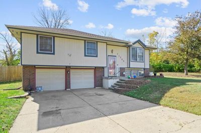 Split foyer home with a garage and a front lawn | Image 2