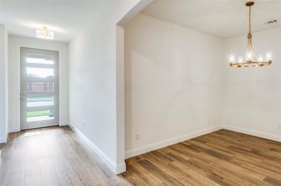 Foyer featuring an inviting chandelier and hardwood / wood-style floors | Image 3