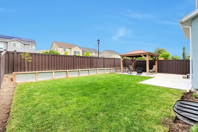 View of yard with a gazebo, a patio area, and a residential view | Image 29