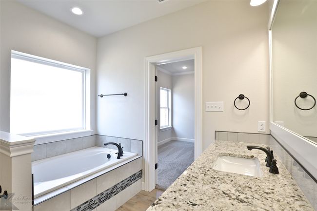 Bathroom with a garden tub, vanity, and recessed lighting | Image 15