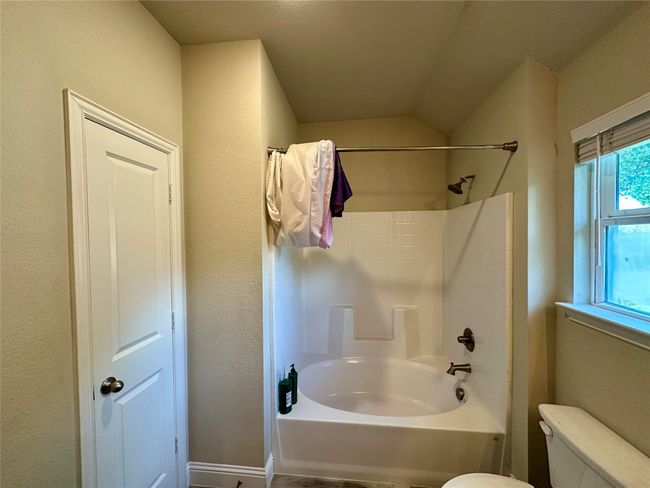 Bathroom featuring toilet and bathing tub / shower combination | Image 32