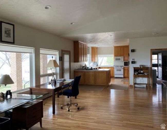 Home office with light wood finished floors and lofted ceiling | Image 4
